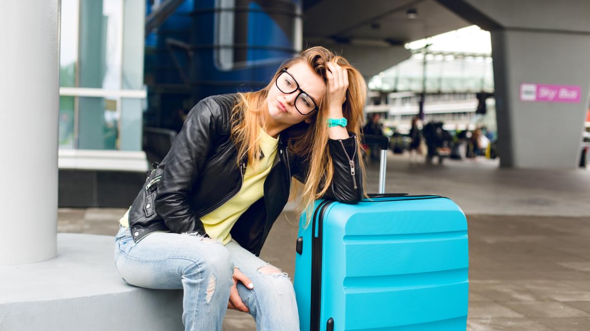 Девушка с чемоданом в аэропорту Девушка с чемоданом в аэропорту